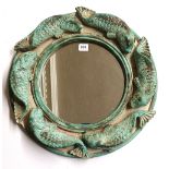 A CIRCULAR MIRROR The heavy cast plaster frame decorated with carp. (diameter 49cm)