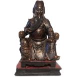 A 19TH CENTURY CHINESE CARVED WOODED FIGURE Seated elder with black and gilt robes. (approx 30cm)