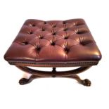 A REGENCY PERIOD FOOT STOOL In burgundy button back leather upholstery, raised on a beech wood frame