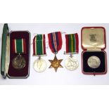 A COLLECTION OF WWII BRITISH WAR MEDALS Two defence medals, a bronze Pacific Star medal, a case