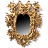 A LARGE CARVED AND GILDED CHIPPENDALE STYLE MIRROR With Hoho birds and deep foliate design. (