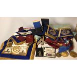 A COLLECTION OF MASONS REGALIA Including gilt medallions, aprons, sashes cuffs and books.