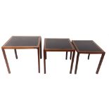 A 20TH CENTURY NEST OF THREE TABLES With brass bound black leather insets. (largest 56cm x 54cm x