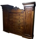 AN EARLY VICTORIAN MAHOGANY COMPACTUM WARDROBE With central bank of long drawers, flanked by hanging