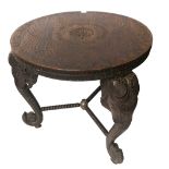 A LATE 19TH/EARLY 20TH CENTURY INDIAN HARDWOOD TABLE The circular top raised on three elephant