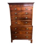 A GEORGIAN MAHOGANY CHEST ON CHEST With two short above six graduated long drawers, on bracket feet.