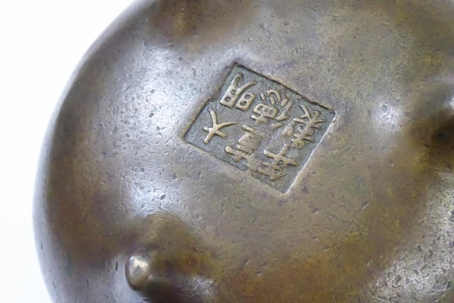 A CHINESE BRONZE CENSOR Spherical form on tripod feet. Bearing a six-character mark to base Approx - Image 9 of 9