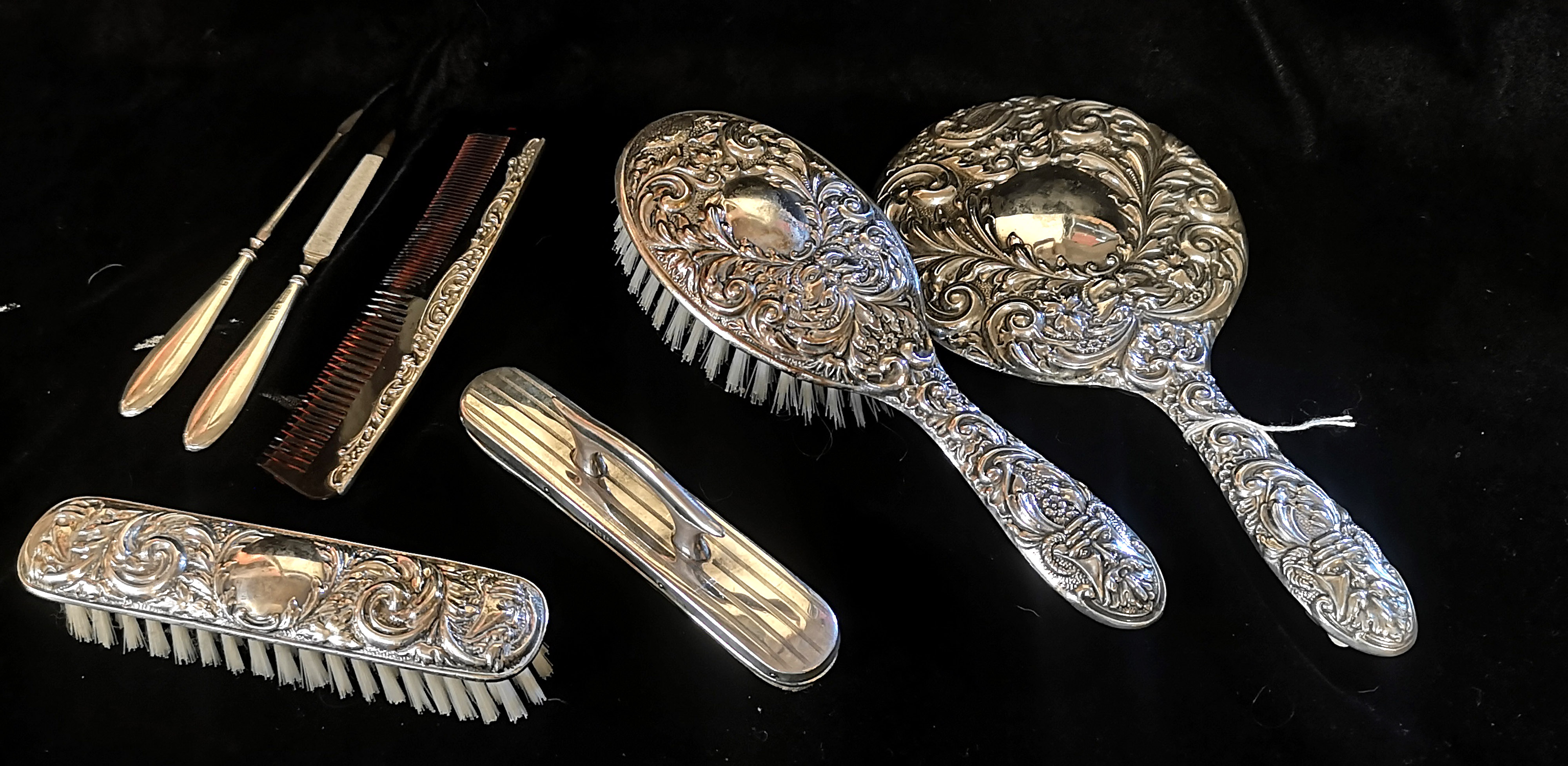 A 20TH CENTURY SILVER BRUSH AND COMB SET Comprising a hand mirror, two brushes and a tortoiseshell