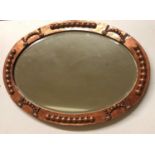 AN ARTS &CRAFTS PERIOD COPPER FRAMED OVAL MIRROR With bevelled silvered plate. (70cm x 49cm)