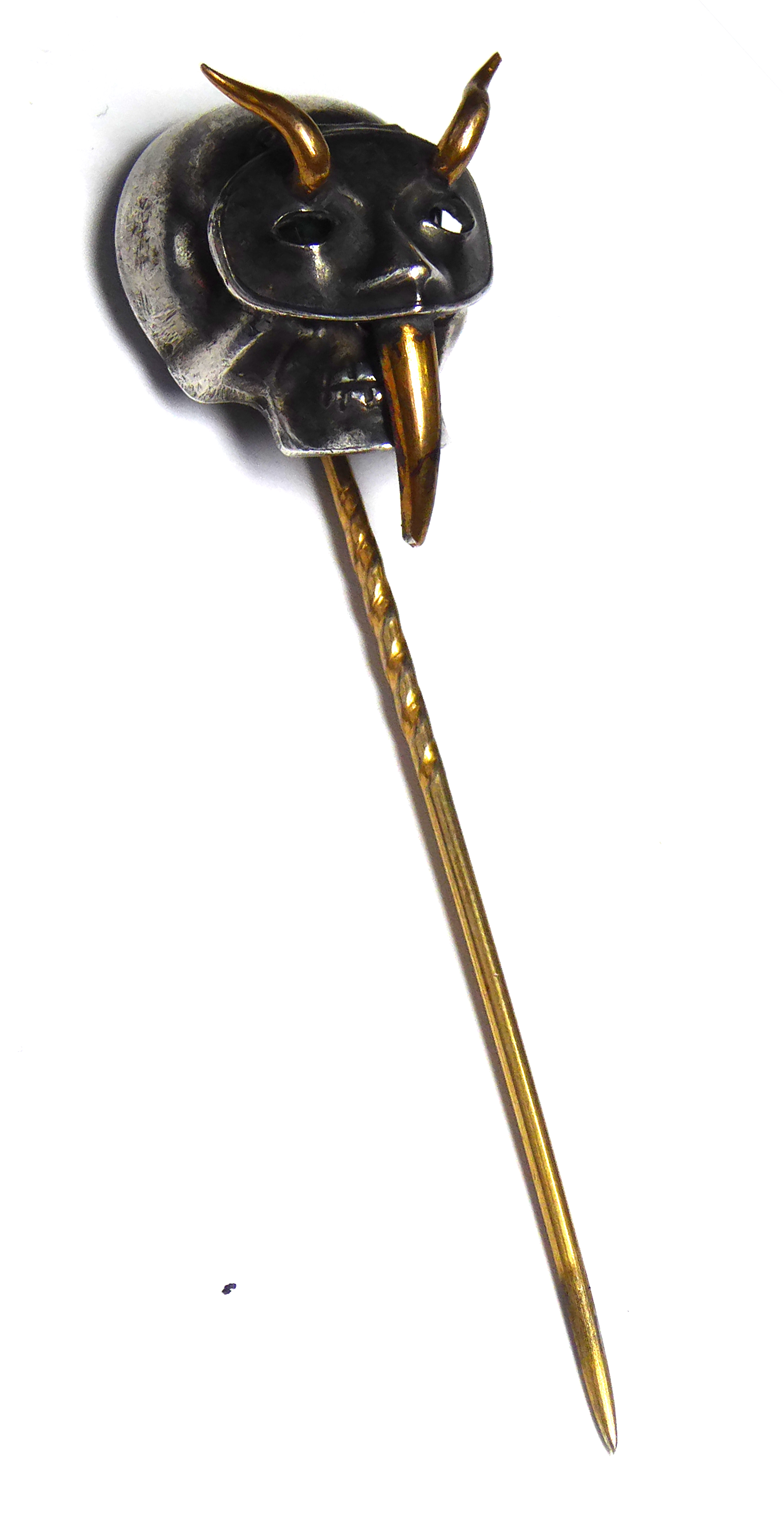 A BI METAL AND GEM SET DEVIL MASK STICK PIN A hinged white metal mask set with gilt metal horns