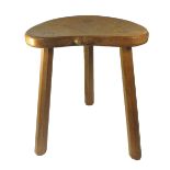 ROBERT MOUSEMAN THOMPSON, AN OAK STOOL With kidney shaped seat, on three faceted legs. 37 x 46cm.