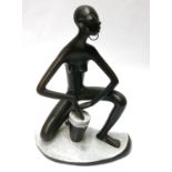 LEOPOLD ANZENGRUBER, A MID 20TH AUSTRIAN POTTERY FIGURINE Native African drummer with elongated