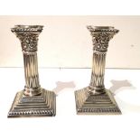 A PAIR OF EDWARDIAN SILVER CANDLESTICKS Classical column form, on a stepped square base,