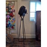 A PAIR OF VINTAGE EBONISED STEEL STUDIO LIGHTS, CIRCA 1940 On a metal tripod base. (overall 205cm)