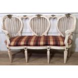 AN ITALIAN LOVE SEAT With three heart shaped back panels above an upholstered seat, raised on