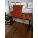 A VICTORIAN MAHOGANY READING TABLE With rise and fall centre section, raised on telescopic