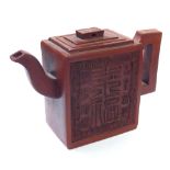 A CHINESE YIXING TERRACOTTA TEAPOT Square form with raised Chinese characters and a four-character