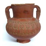 A ROMAN SAMIAN WARE TERRACOTTA TWIN HANDLED VASE Finely carved with a band of anthemons and