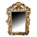 A LARGE EARLY 19TH CENTURY ITALIAN MIRROR The heavily carved pierced giltwood and painted frame in