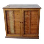A VICTORIAN OAK SCIENTISTS COLLECTORS CABINET With two glazed doors enclosing 60 drawers, bearing