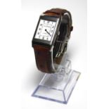JAGUER LE COULTRE, A GENTLEMAN'S STAINLESS STEEL REVERSO WATCH On tan leather strap, boxed with