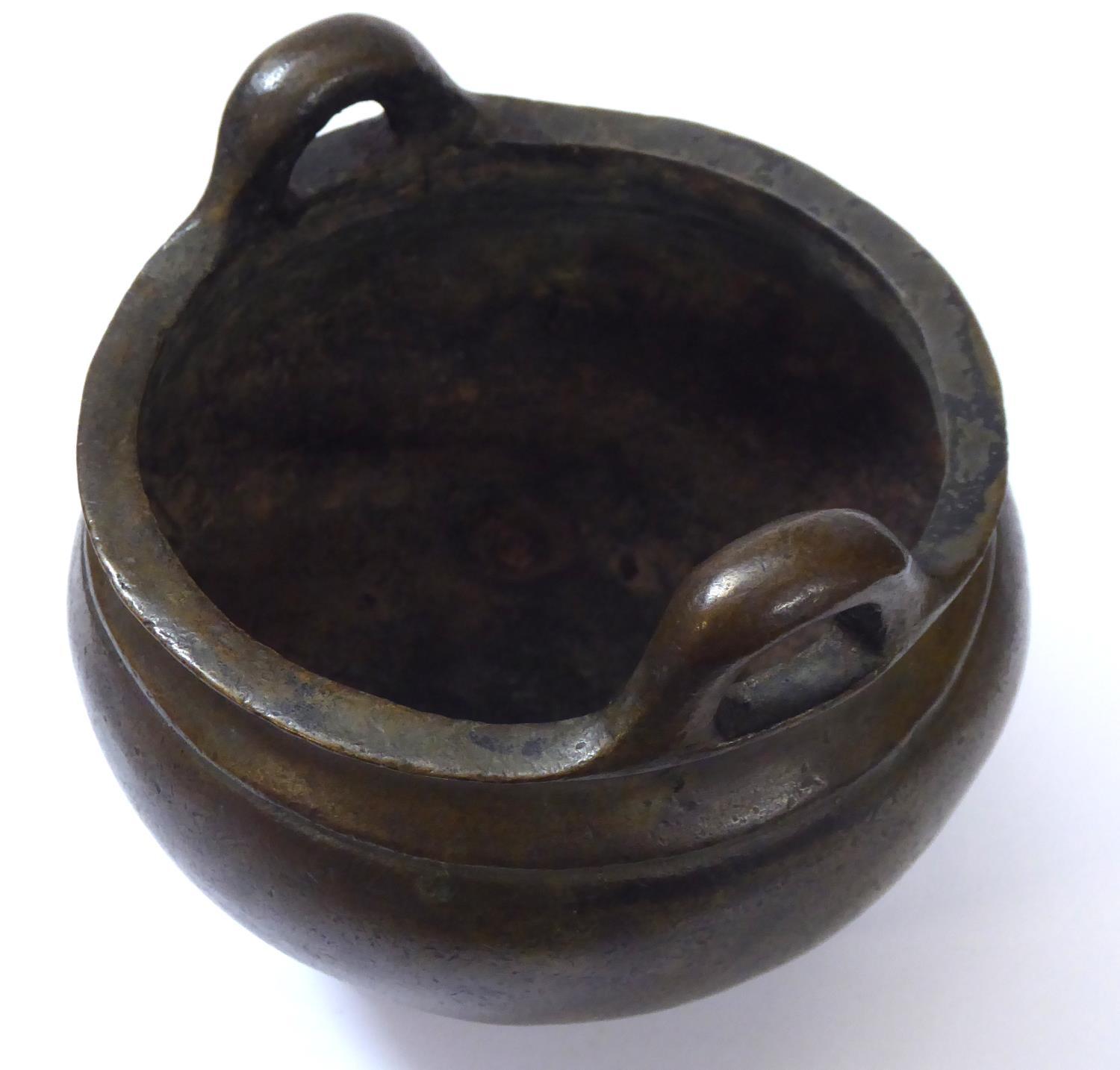 A CHINESE BRONZE CENSOR Spherical form on tripod feet. Bearing a six-character mark to base Approx - Image 5 of 9