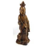 A CHINESE SOAPSTONE CARVING Modelled as a female figure with a Dog of Fo at her side. (h 28cm)