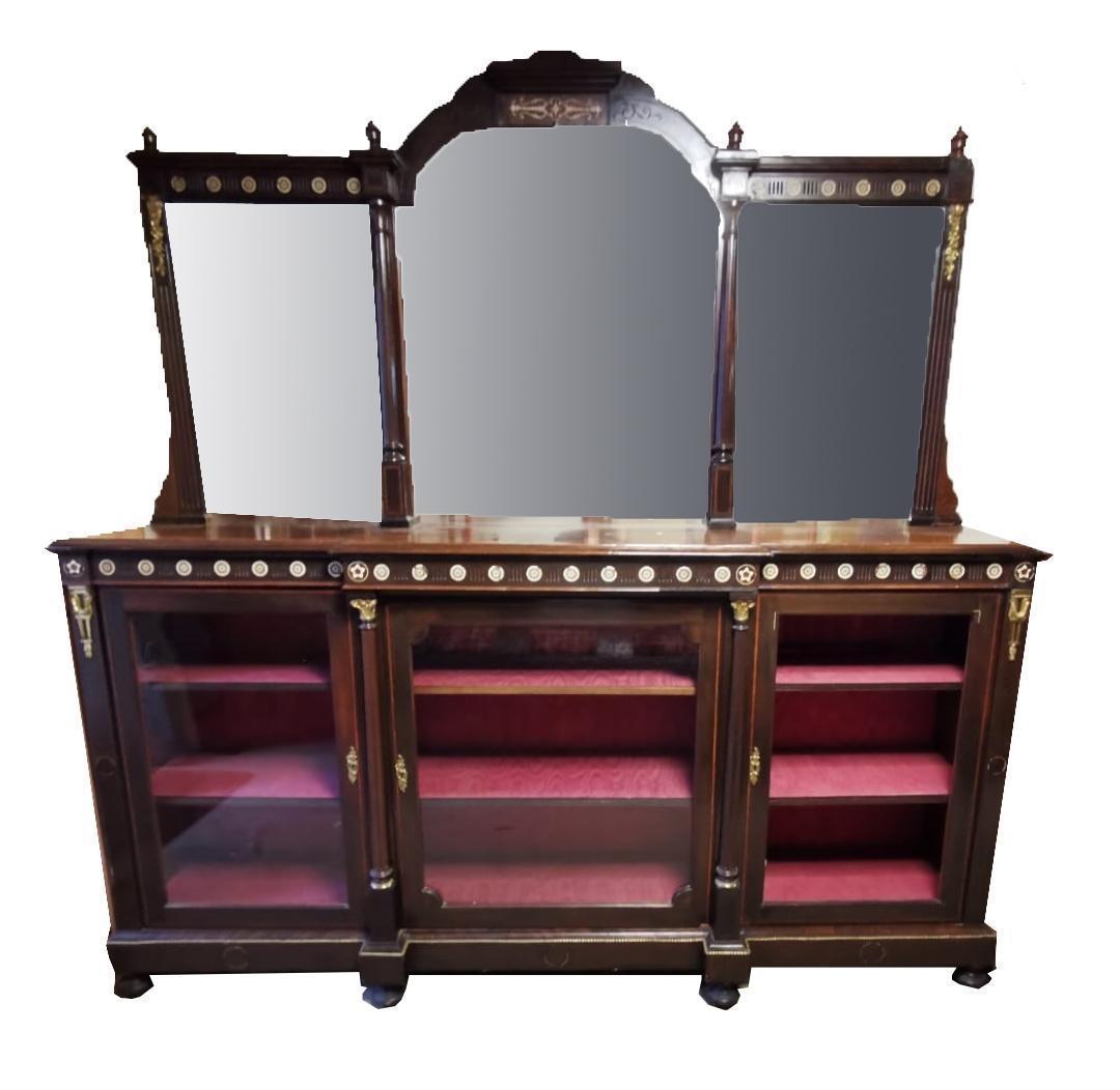 IN THE MANNER OF GILLOWS, A VICTORIAN AESTHETIC MAHOGANY MIRROR BACK BREAKFRONT BOOKCASE With box