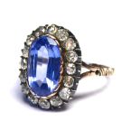 A YELLOW METAL (TESTS AS 9CT), 19TH CENTURY NATURAL SRI LANKAN SAPPHIRE AND DIAMOND RING The oval