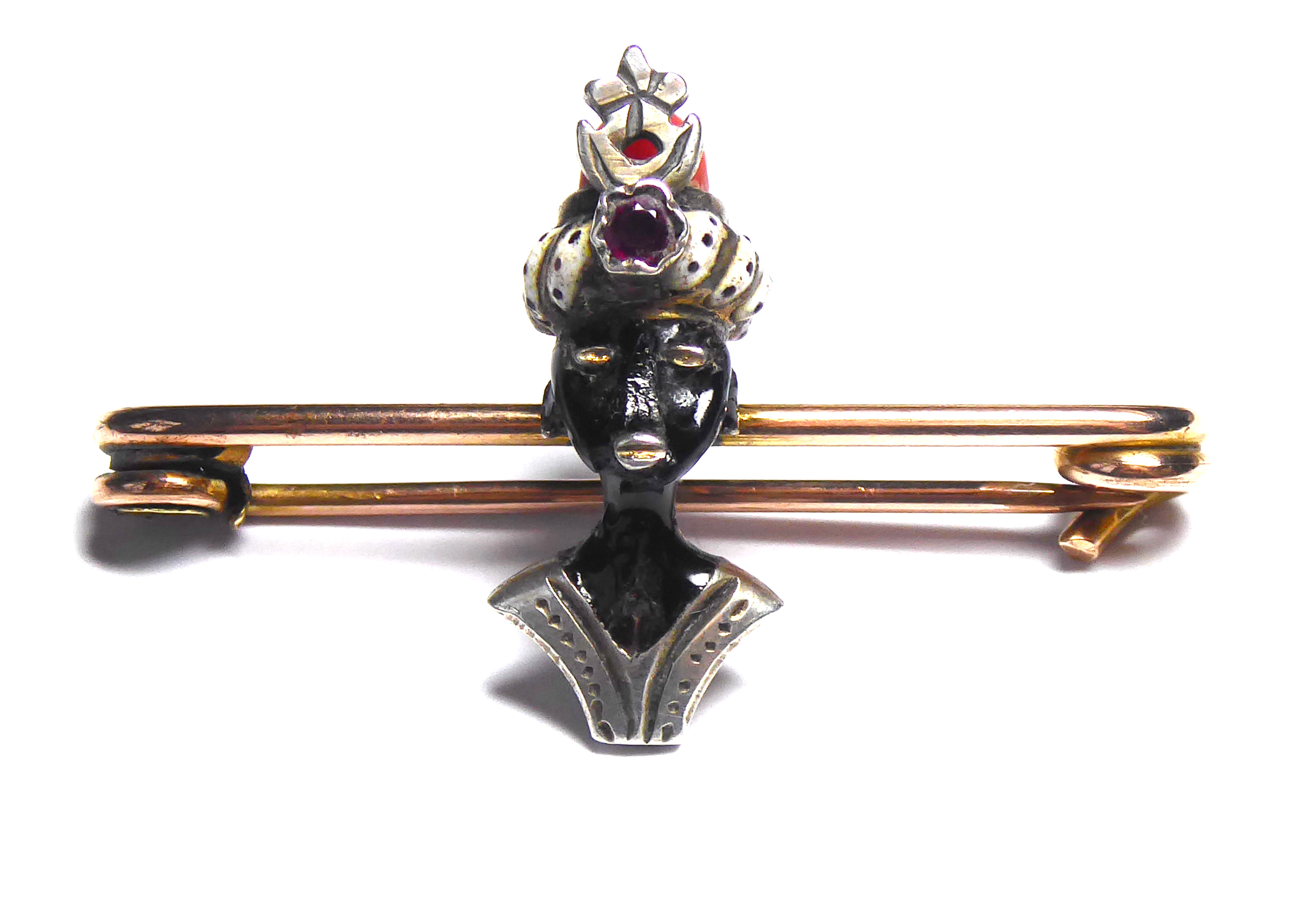 A BI METAL, ENAMEL, AMETHYST AND CORAL VENETIAN BLACKAMOOR STICK PIN A black enamel female bust with