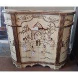A 20TH CENTURY SIDE CABINET With japanned decoration on a cream ground, the inverted bow front