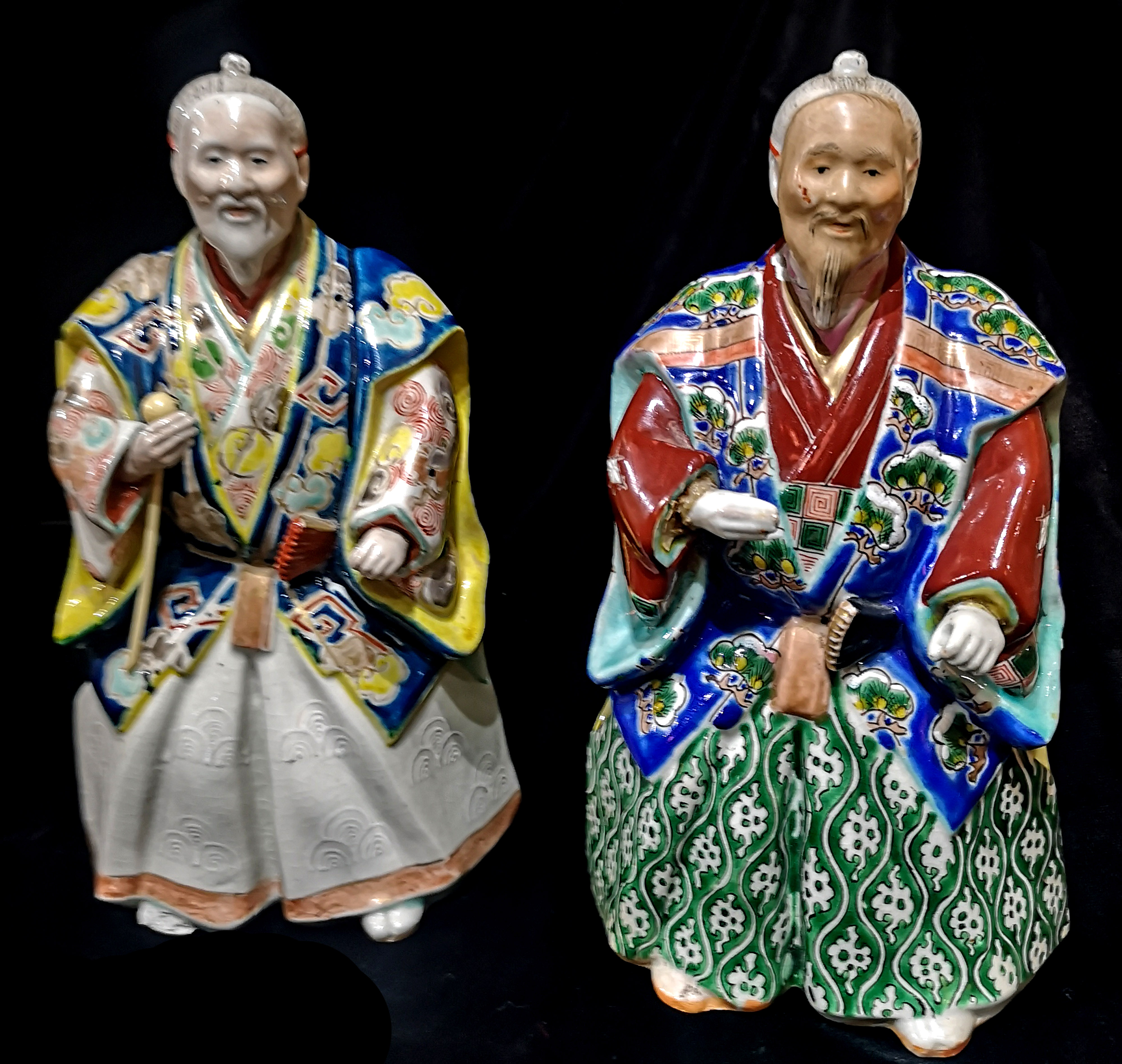 A PAIR OF CHINESE PORCELAIN FIGURINES Elders wearing period clothing with enamel decoration. (approx