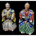 A PAIR OF CHINESE PORCELAIN FIGURINES Elders wearing period clothing with enamel decoration. (approx