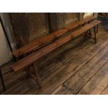 A PAIR OF 19TH CENTURY FRENCH FRUITWOOD BENCHES The single 3cm solid plank tops raised on splayed