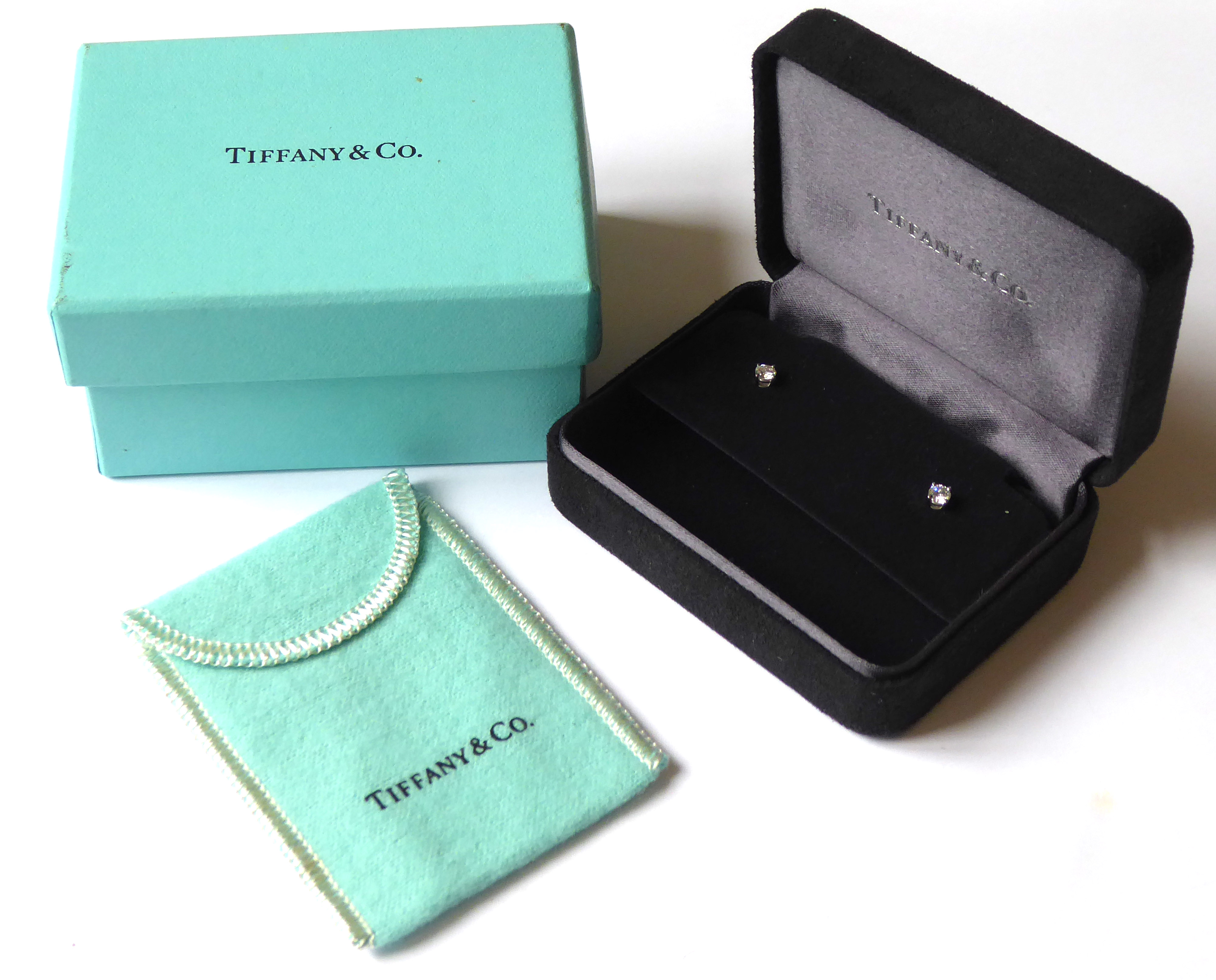 TIFFANY & CO., A PAIR OF PLATINUM AND DIAMOND STUD EARRINGS Plain form complete with fitted velvet