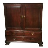 AN 18TH CENTURY MAHOGANY DWARF LINEN PRESS With two fielded panelled doors above two short and one