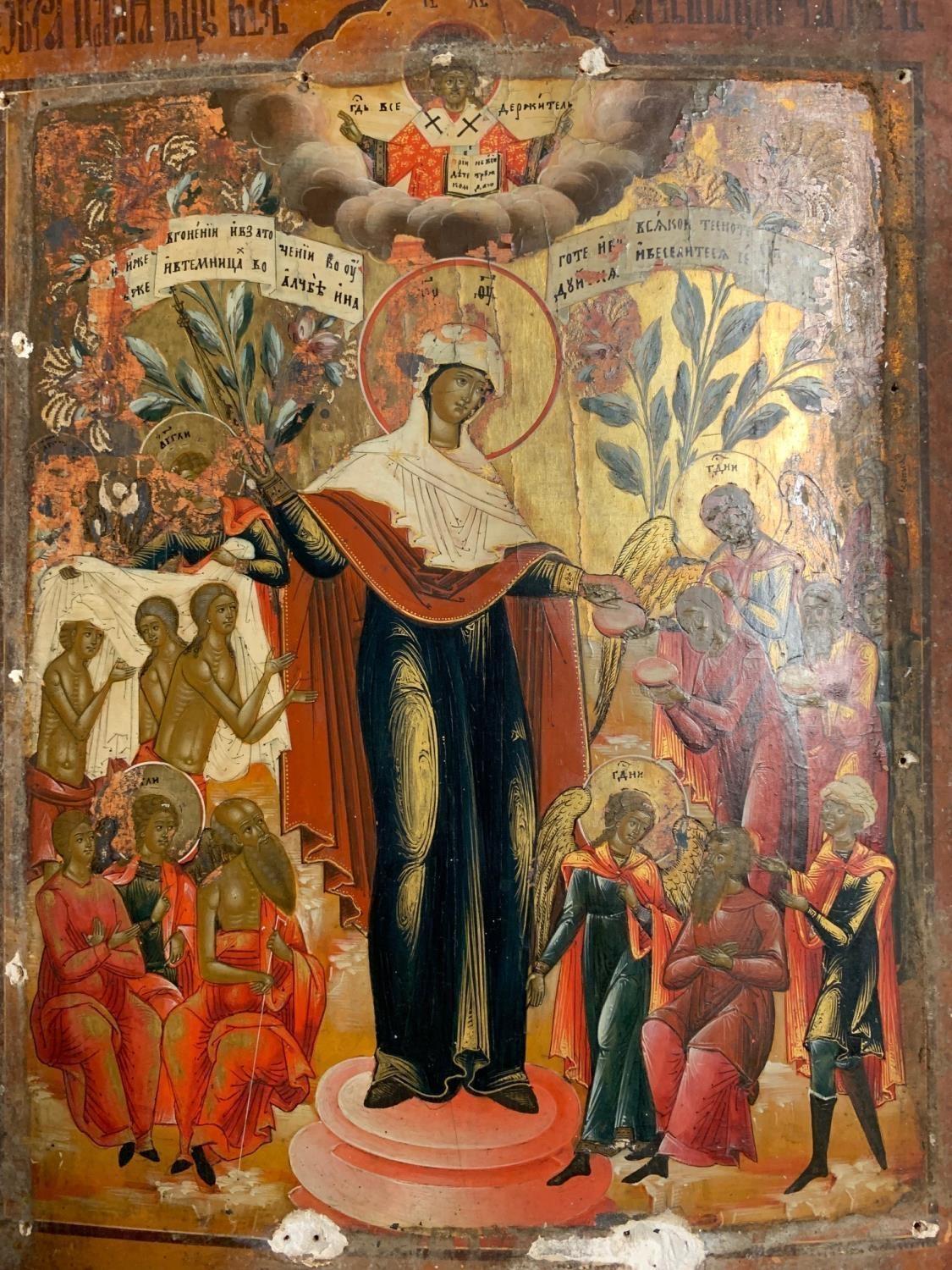 A 18TH CENTURY RUSSIAN ICON ON PANEL Hand painted with Madonna and figures on gilt ground having a