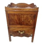 A GEORGIAN MAHOGANY BEDSIDE NIGHT CABINET With galleried top above cupboards and pull out