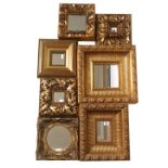 A COLLECTION OF SEVEN 20TH CENTURY GILT FRAMED MIRRORS Two cushion form with carved leaf