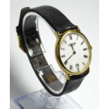RAYMOND WEIL, AN 18CT GOLD PLATED GENT'S WRISTWATCH Oval white dial on a black leather strap with RE