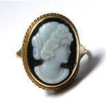 A 9CT GOLD AND HARDSTONE CAMEO RING Oval form on pierced gold shank (size P). (cameo approx 1.5cm