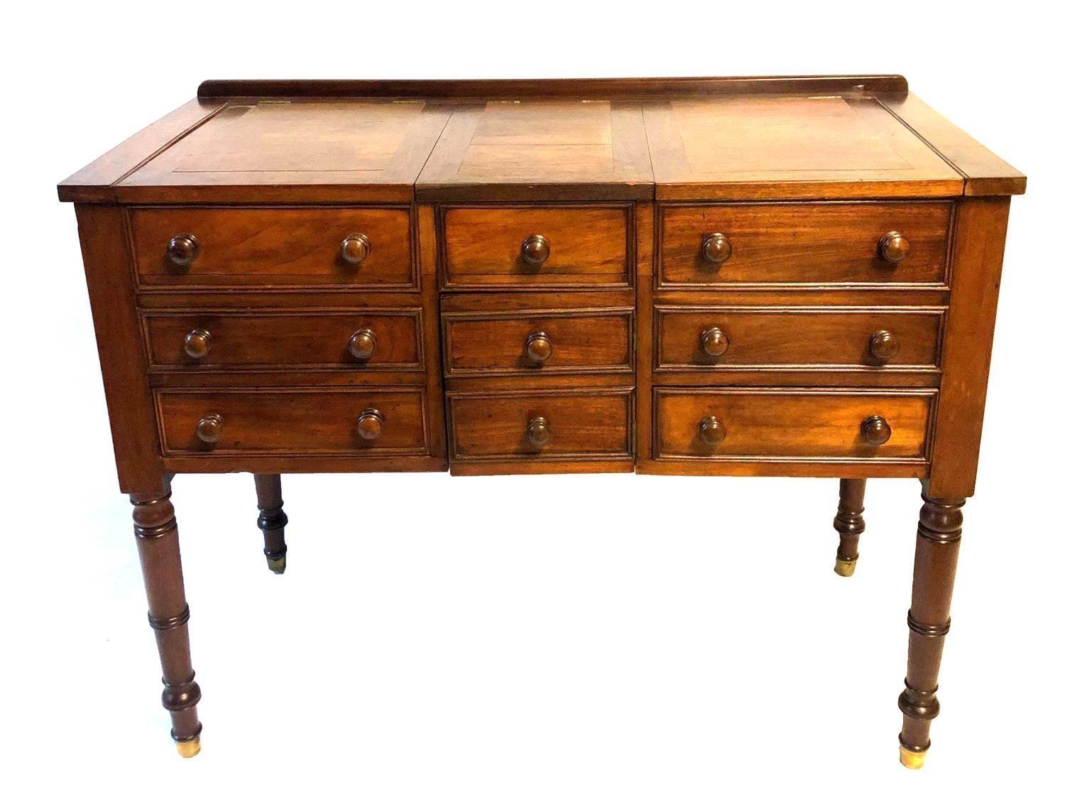 AN EARLY VICTORIAN MAHOGANY GENTLEMAN'S DRESSING CABINET With rise and fall tops, the centre