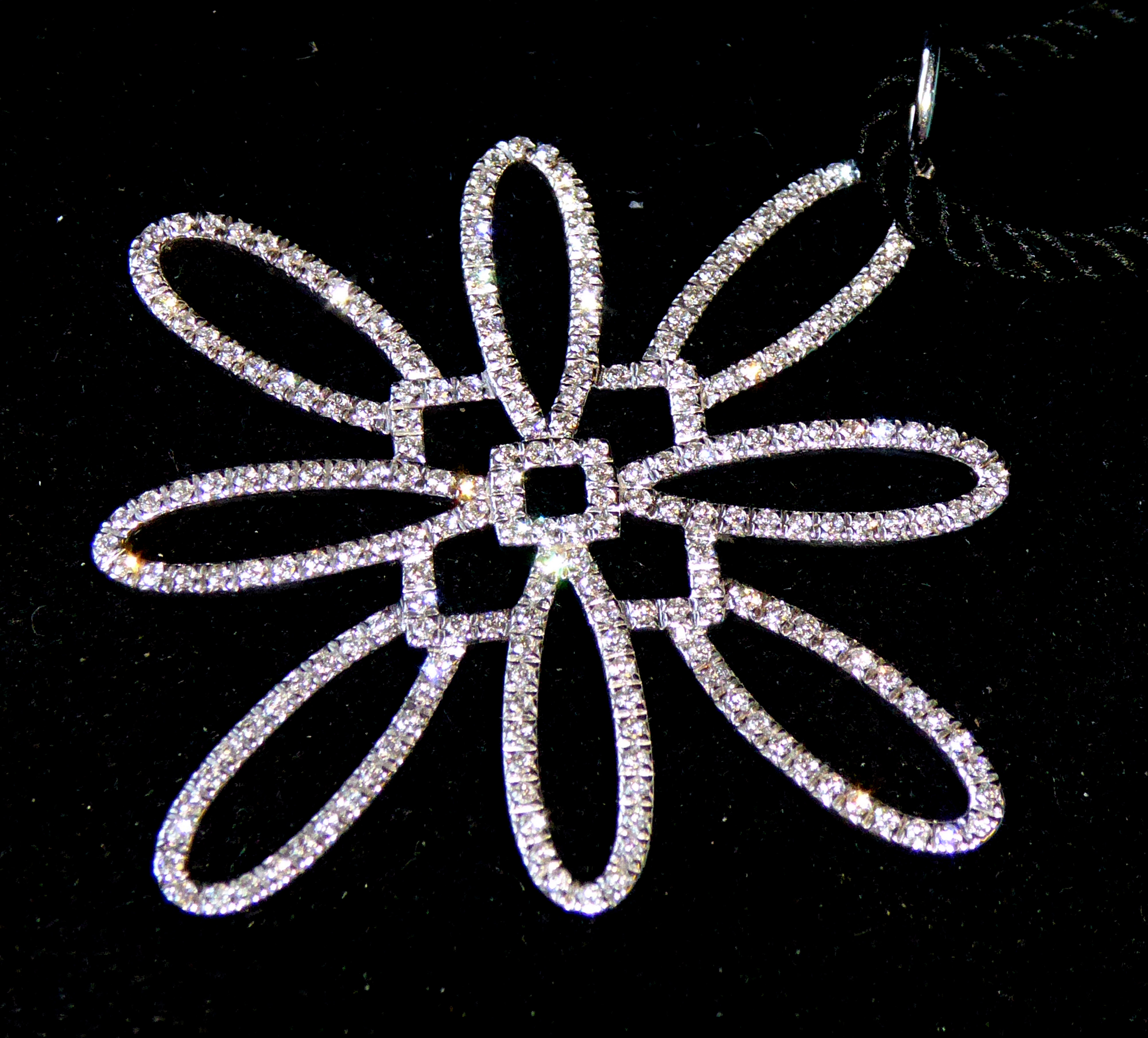 TIFFANY & CO., AN 18CT WHITE GOLD AND DIAMOND PENDANT The single strand of diamonds in a floral