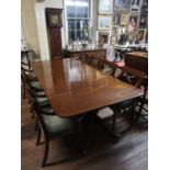 AN EARLY 20TH CENTURY REGENCY DESIGN MAHOGANY EXTENDING DINING TABLE With two extra leaves, raised