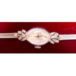LONGINES, A VINTAGE 14CT WHITE GOLD AND DIAMOND LADIES' COCKTAIL WRISTWATCH Having an oval form