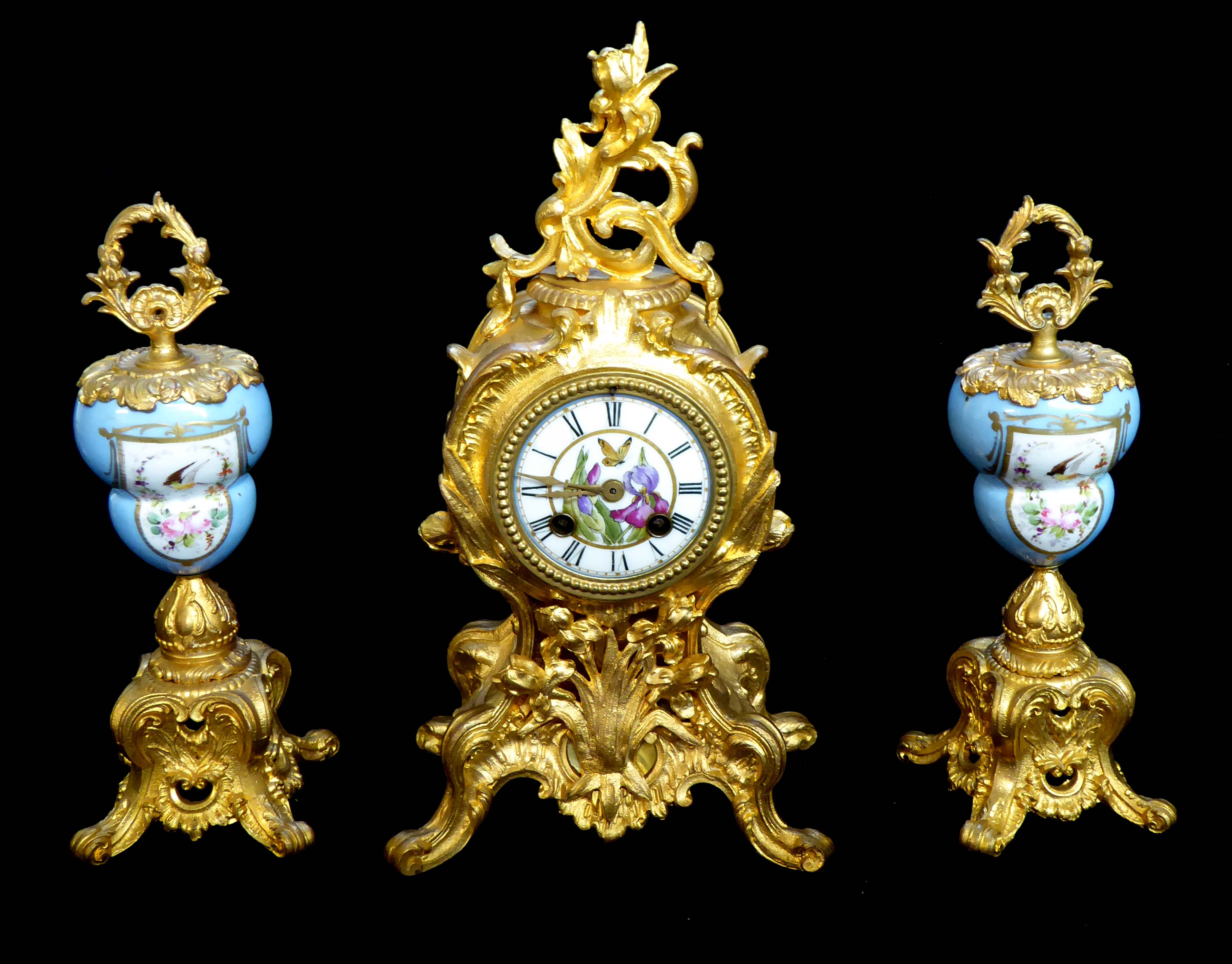 A 19th CENTURY FRENCH SPELTER ORMOLU AND PORCELAIN CLOCK GARNITURE Rococo form with painted