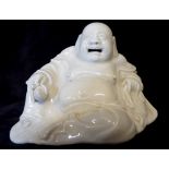 A CHINESE BLANC DE CHINE PORCELAIN BUDDHA In seated pose holding a peach Inscribed in pencil to base