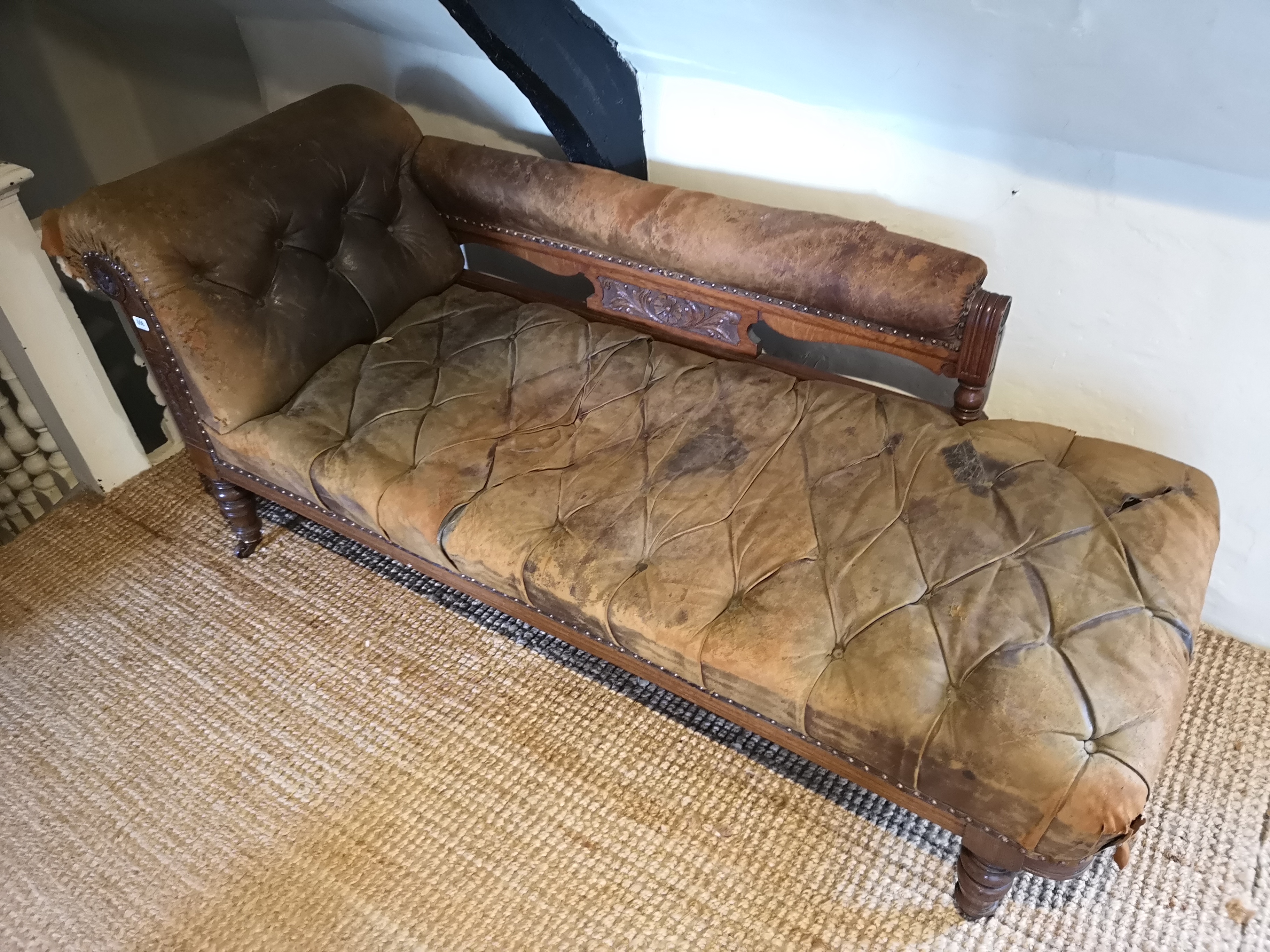 AN EDWARDIAN SATIN WALNUT CHAISE LOUNGE Upholstered in a distressed Moroccan tan leather. (180cm x