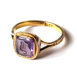 A VICTORIAN 9ct GOLD AND AMETHYST INTAGLIO SIGNET RING Square form carved with a gothic monogram