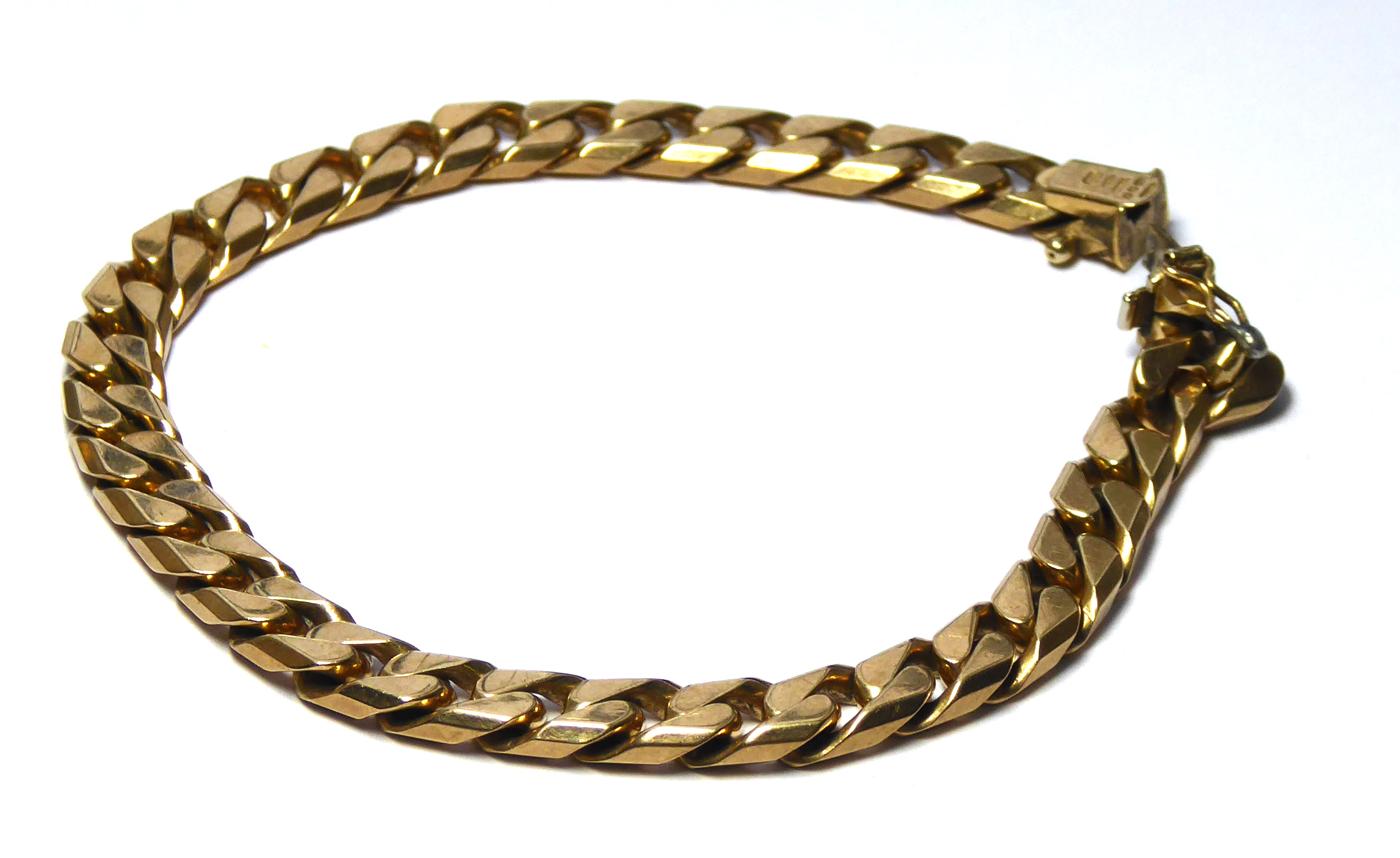 A VINTAGE 9CT GOLD CURB LINK BRACELET Having heavy gauge links. (approx 22cm)